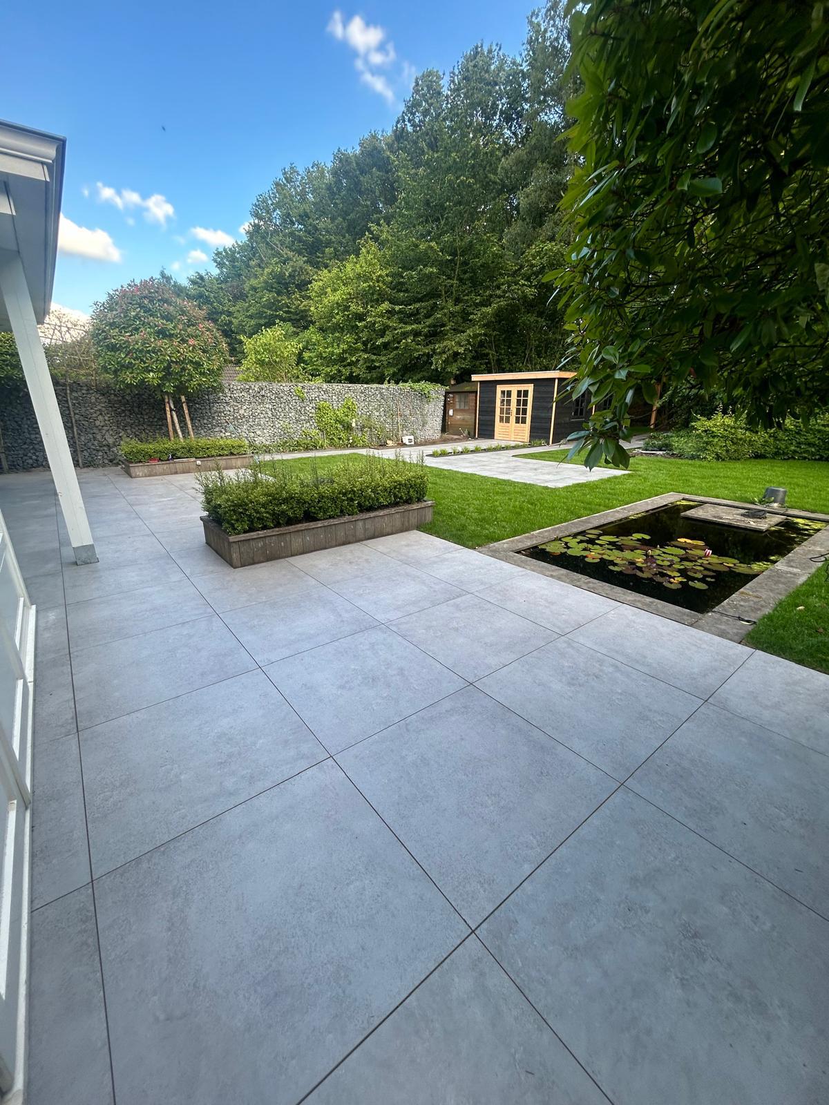 Tuin met gazon, vijver en terras